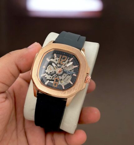 Elevate your style with the unparalleled sophistication of the Patel Philippe Skeleton Watch. Crafted for modern men with a taste for precision and elegance, this watch is a true statement piece. Featuring a skeleton open machine design, the intricate inner workings are on full display, blending artistry and high-end craftsmanship. The pure Swiss automatic movement guarantees unmatched accuracy and reliability, while the Japanese heavy machinery ensures durability that lasts a lifetime. This masterpiece comes with a round black and silver case paired with a comfortable silicone strap, combining luxury and everyday practicality. Designed for the ultimate convenience, its clip lock ensures a secure fit. The 12-hour dial offers clarity, making it a functional and stylish companion for any occasion. When you choose this watch, you’re not just buying a timepiece; you’re investing in a legacy of innovation, sophistication, and style. Guaranteed delivery of the exact product as pictured—no surprises, just perfection! 💯 Product Details Brand: Patel Philippe Target Audience: Men Model: Original, 7AAA Case Type: Round Feature: Skeleton open machine Movement: Pure Swiss automatic Inner Machinery: Guaranteed Japanese heavy machinery Dial: 12-hour format Case Color: Black and silver Strap Material: Silicone Strap Closure: Clip lock Delivery Guarantee: Product matches exactly as pictured and video